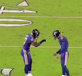 a football player with the number 37 on his jersey stands on the field