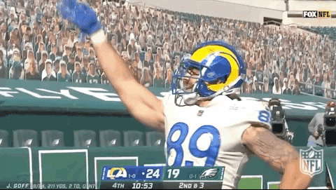 A Football Player With The Number 39 On His Jersey Celebrates A Touchdown GIF