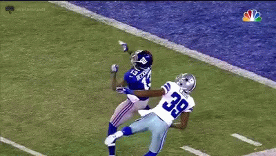 A Football Player With The Number 39 On His Jersey Is Trying To Catch The Ball GIF
