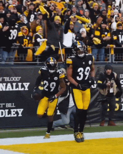A Football Player With The Number 39 On His Jersey Runs On The Field GIF