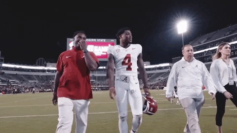 a football player with the number 4 on his jersey is walking on the field