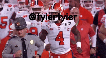 A Football Player With The Number 4 On His Jersey Runs Past A Police Officer GIF