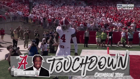 a football player with the number 4 on his jersey stands on the field