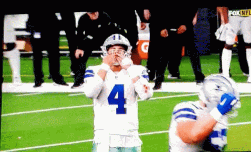 A Football Player With The Number 4 On His Jersey Stands On The Field GIF