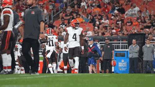 A Football Player With The Number 4 On His Jersey Walks On The Field GIF