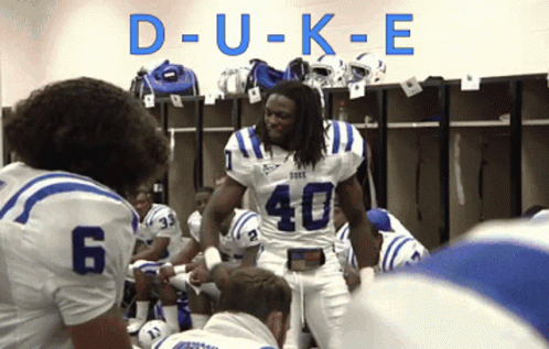 A Football Player With The Number 40 On His Jersey Stands In A Locker Room GIF