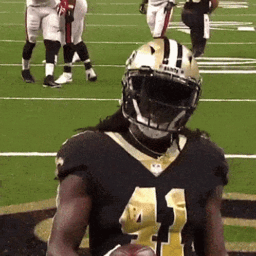 A Football Player With The Number 41 On His Jersey Is Holding A Football GIF