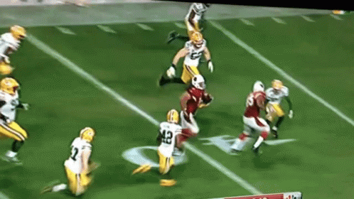 A Football Player With The Number 42 On His Jersey Is Being Tackled By Another Player GIF