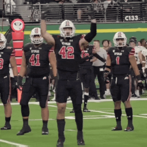 A Football Player With The Number 42 On His Jersey Stands On The Field GIF