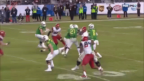 A Football Player With The Number 45 On His Jersey Is Being Tackled GIF