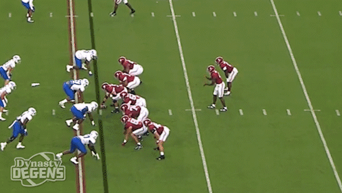 a football player with the number 5 on his jersey is being tackled