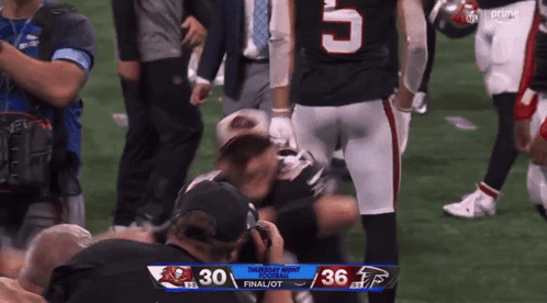 A Football Player With The Number 5 On His Jersey Is Kneeling On The Field GIF