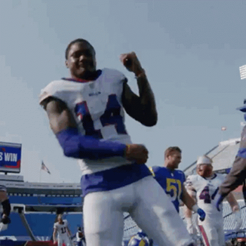 A Football Player With The Number 51 On His Jersey Is Dancing GIF