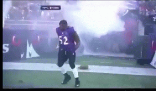 A Football Player With The Number 52 On His Jersey Is Dancing On The Field GIF