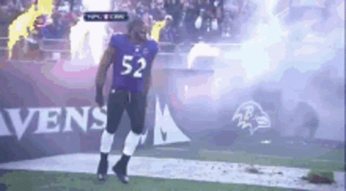 A Football Player With The Number 52 On His Jersey Is Walking On The Field GIF