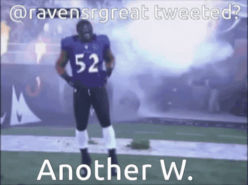A Football Player With The Number 52 On His Jersey Stands On A Field GIF