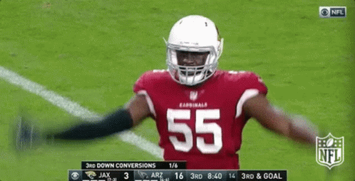 A Football Player With The Number 55 On His Jersey Is Standing On The Field GIF