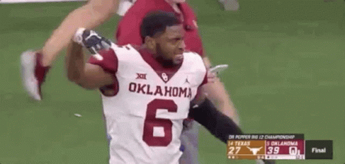 A Football Player With The Number 6 On His Jersey Is Running On The Field . GIF