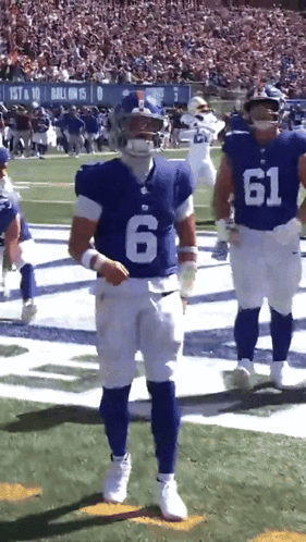 A Football Player With The Number 6 On His Jersey Stands On The Field GIF
