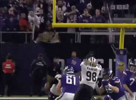 A Football Player With The Number 61 On His Jersey Is Being Tackled By Another Player GIF