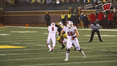 Football Player With Number 65 Running GIF