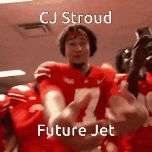 A Football Player With The Number 7 On His Jersey Is Being Hugged By His Teammates . GIF