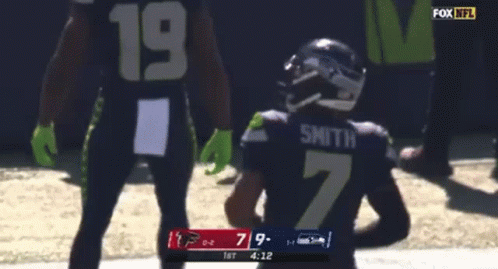 A Football Player With The Number 7 On His Jersey Is Running With The Ball GIF
