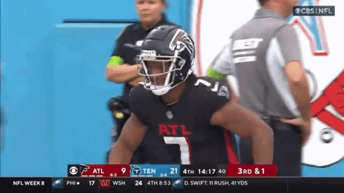 A Football Player With The Number 7 On His Jersey Stands In Front Of A Referee GIF