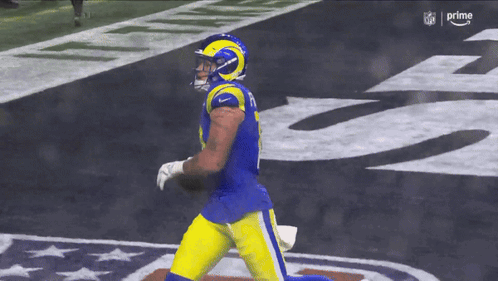 A Football Player With The Number 8 On His Jersey Is Running With The Ball GIF