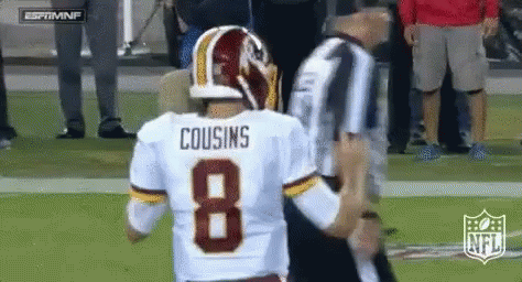 A Football Player With The Number 8 On His Jersey Is Talking To A Referee . GIF