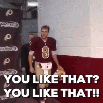 A Football Player With The Number 8 On His Jersey Is Walking Down A Hallway GIF