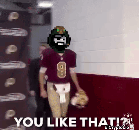 A Football Player With The Number 8 On His Jersey Is Walking Down A Hallway GIF