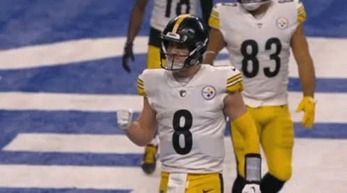 A Football Player With The Number 8 On His Jersey Is Walking On The Field GIF