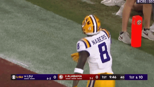 A Football Player With The Number 8 On His Jersey Stands On The Field GIF