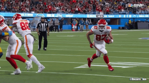 A Football Player With The Number 82 On His Jersey Runs With The Ball GIF