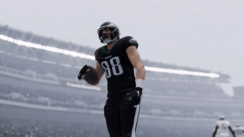a football player with the number 88 on his jersey holds a ball
