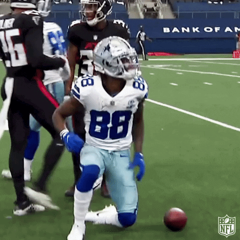 A Football Player With The Number 88 On His Jersey Is Kneeling Down On The Field GIF