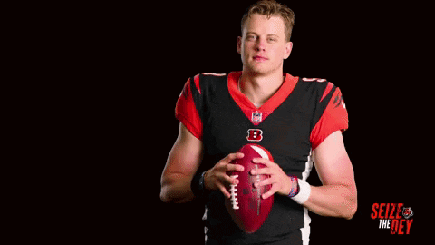A Football Player With The Number 9 On His Jersey Is Holding A Football GIF