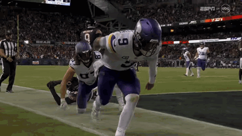 A Football Player With The Number 9 On His Jersey Is Running On The Field GIF