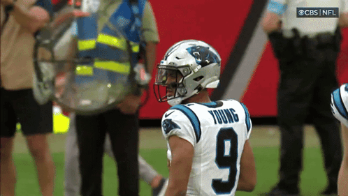 A Football Player With The Number 9 On His Jersey Stands On The Field GIF