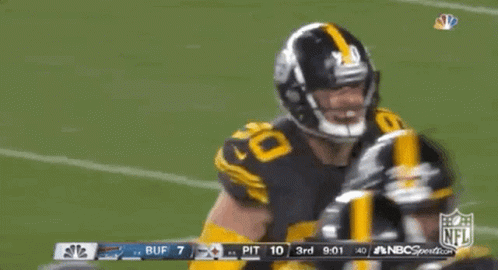 A Football Player With The Number 90 On His Jersey Is Dancing On The Field GIF