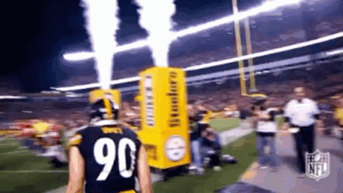 A Football Player With The Number 90 On His Jersey Is Walking On The Field GIF