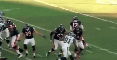 a football player with the number 91 on his jersey is being tackled by another player