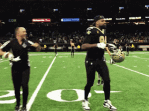 A Football Player With The Number 91 On His Jersey Is Dancing GIF