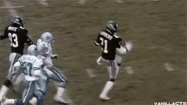 A Football Player With The Number 93 On His Back Is Jumping In The Air GIF