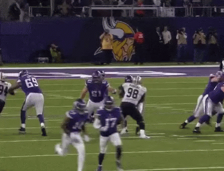 A Football Player With The Number 98 On His Jersey Is Running On The Field GIF