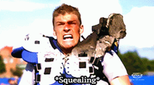 A Football Player With The Word Squealing Written On His Shirt GIF