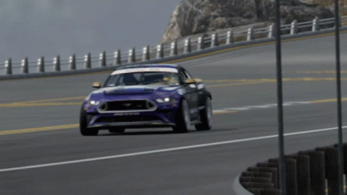 a ford mustang is driving down a road in a video game