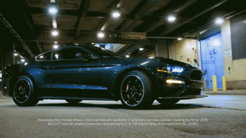 a ford mustang is parked in front of a warehouse