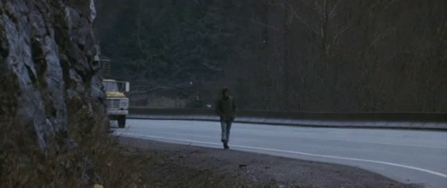 A Ford Truck Is Driving Down The Road Next To A Van GIF